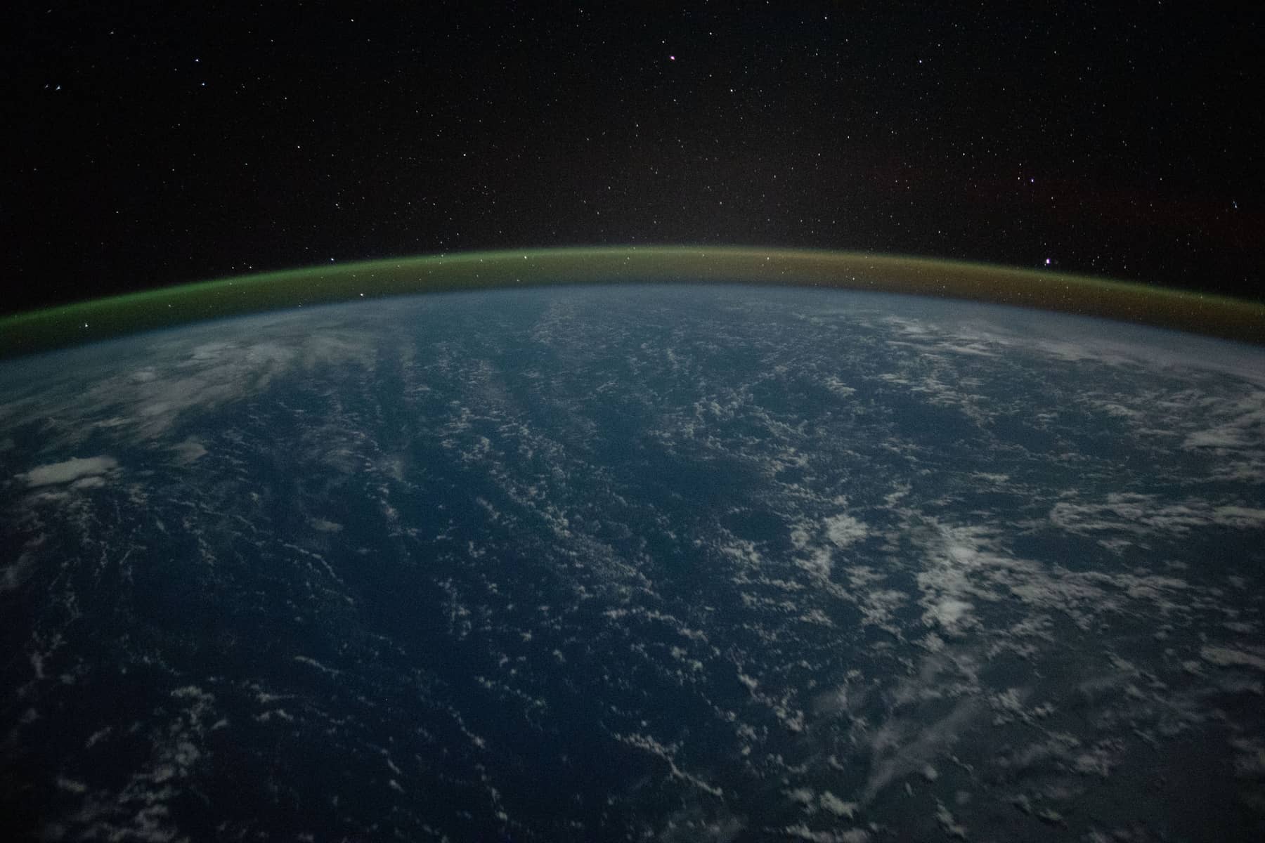 Earth's atmosphere glowing along the horizon, seen from orbit