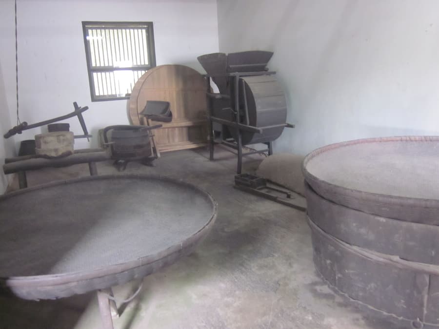 Traditional rice milling equipment in a mill room